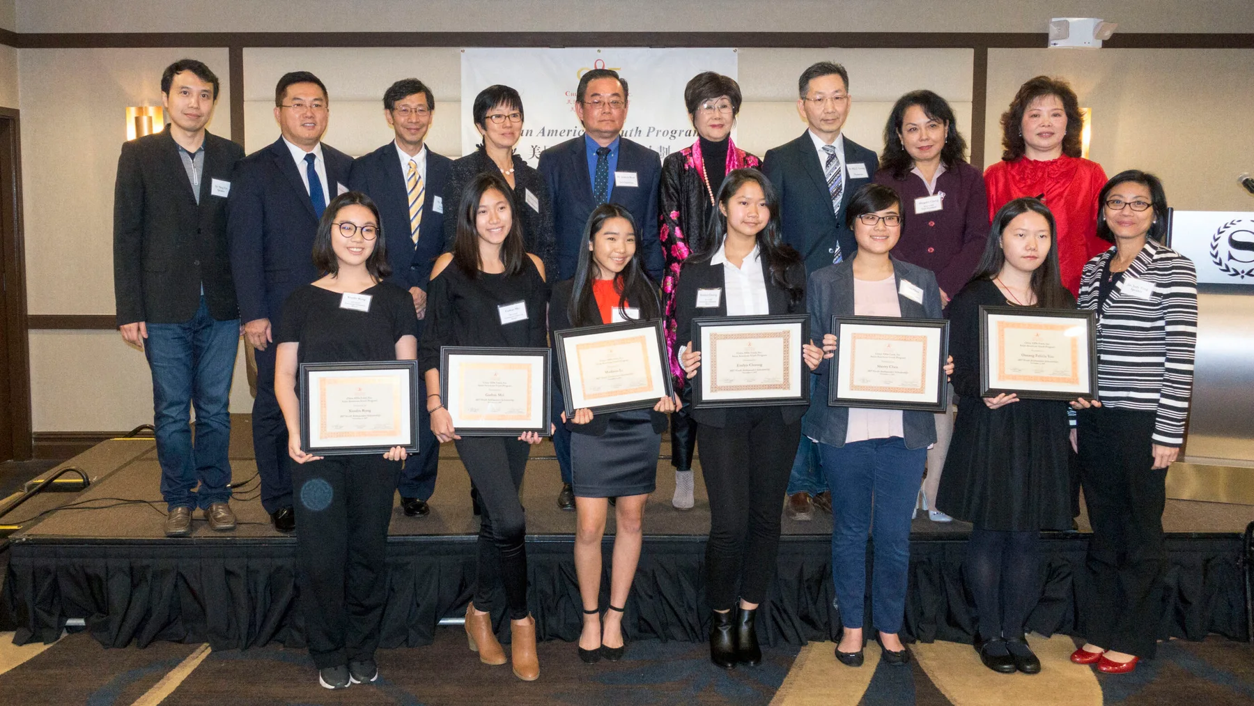 CAAF board members with the Youth Ambassadors Scholarship winners holding their certificates.