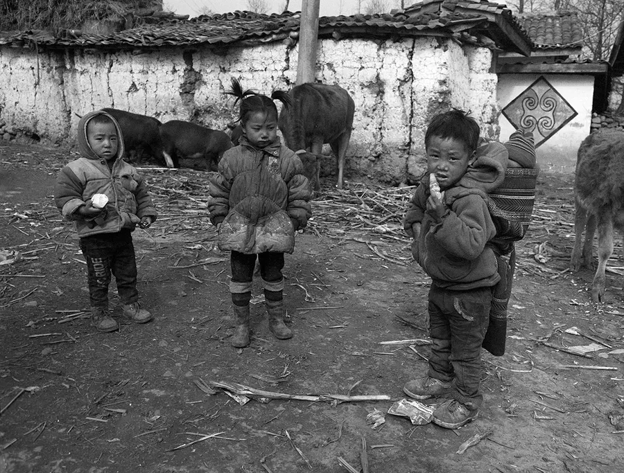 Children in a village yard, Liangshan Prefecture.
