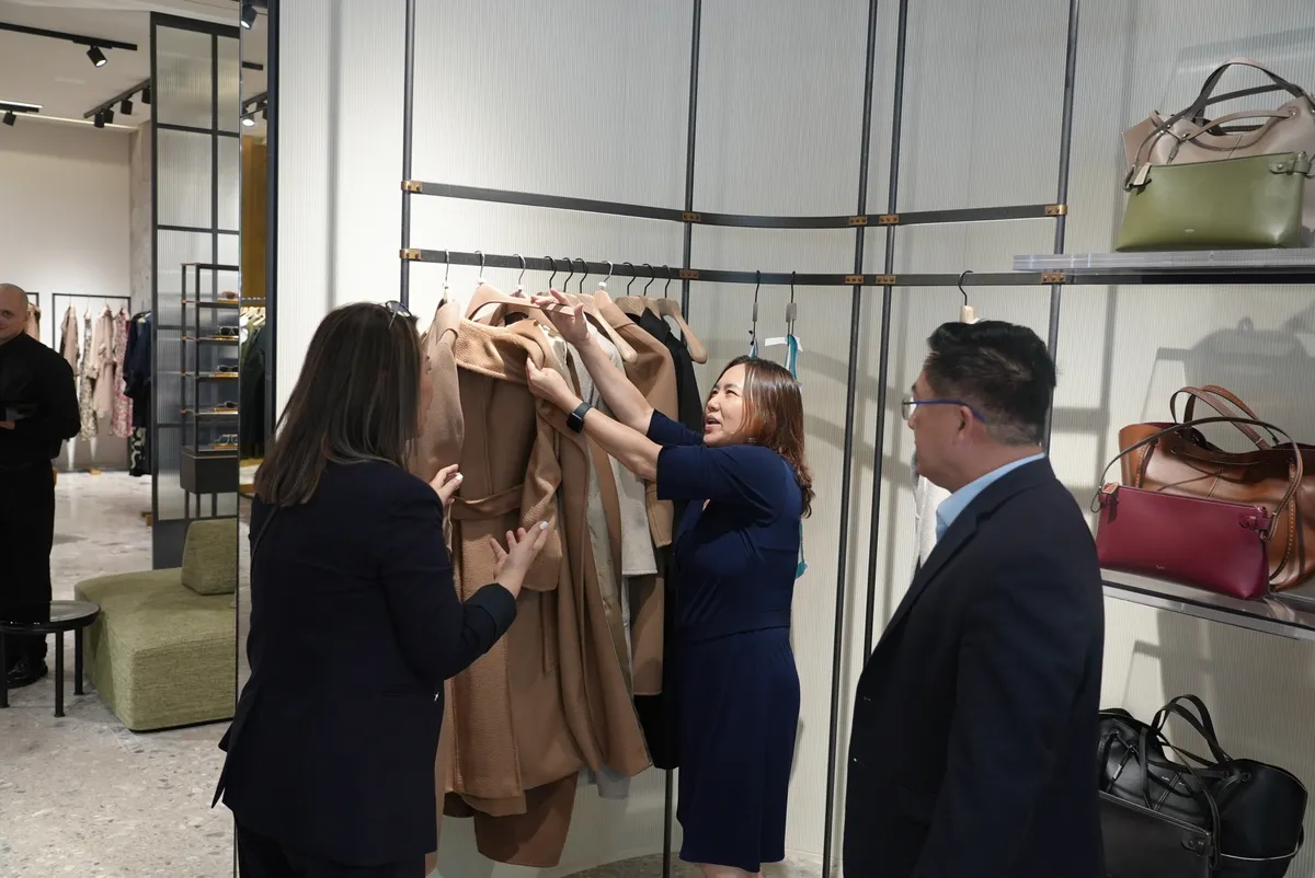 Guests looking through the Fall/Winter collection with a member of the store team.